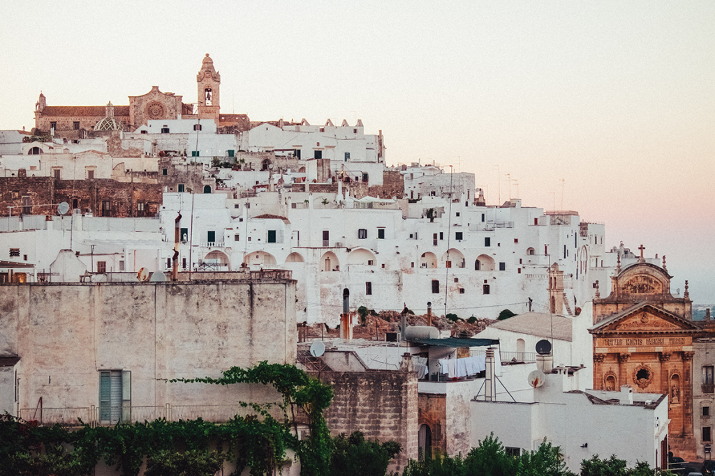 white city of italian crotone italy with a red church at the hilltop