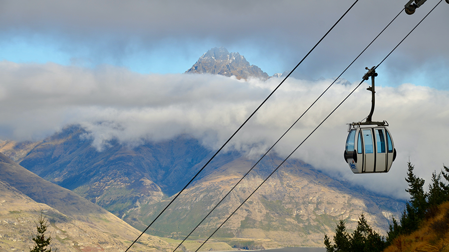 gondola taking passengers up the montain in queenstown, new zealand