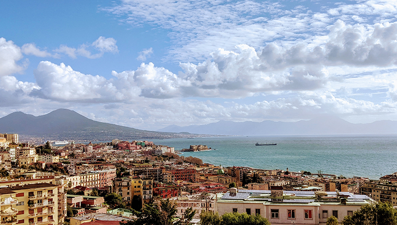 landscape view of the busy Italian sea city of naples with mount vesuvis in the image