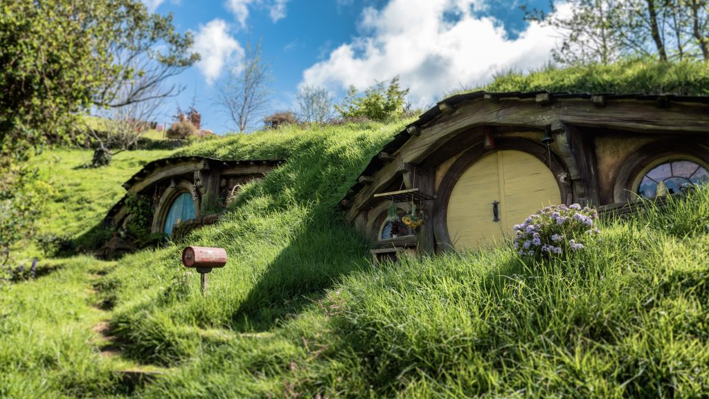 Circular door with green grass roof of the Hobbiton Movie Set, New Zealand