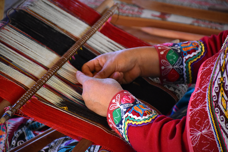 woman weaving a traditional peruvian tapestry