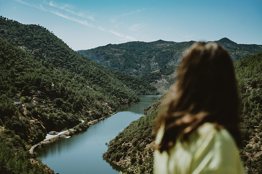 Woman over looking the lush Douro Valley River in the fall