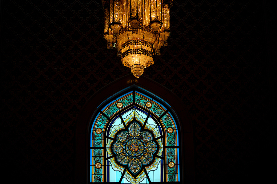 blue floral cathedral window with chandelier in oman